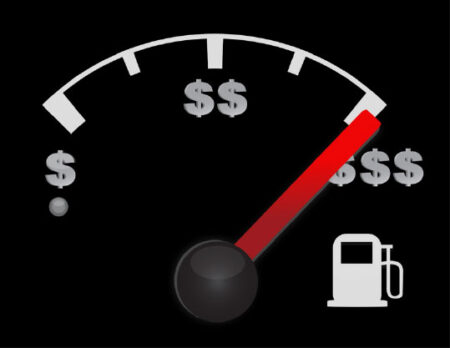 Close-up of a vehicle fuel gauge, with the levels labeled with dollar signs
